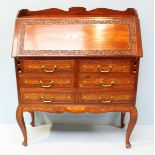 A 20th century mahogany bureau, the front decorated with floral brass inlay, surrounded by floral