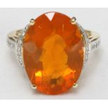 An 18ct yellow gold, diamond and 'Fire Opal,' dress ring, centrally claw-set a large oval faceted