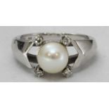 An 750 white gold, pearl and diamond ring, centrally claw-set a cultured pearl measuring approx 7.