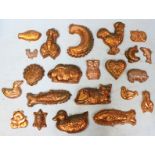 A collection of twenty-two pressed copper jelly and mouse moulds.