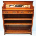 An Edwardian stained walnut open bookcase, with galleried top above a pair of frieze drawers leading