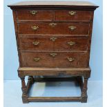 An early 18th Century oak chest-on-stand, with two short over three long graduated drawers with