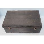 A black painted tin trunk, with hinged top, opening to reveal storage space and a handle to each