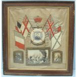 A WW1 framed silk embroidered panel, with three monochrome portrait photographs, one mounted in a