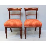 A pair of George IV mahogany standard chairs, with striped salmon fabric upholstery, frilled gimp