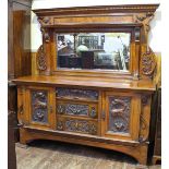 An Edwardian burr walnut and carved walnut sideboard, with raised mirrored back, fluted pilasters