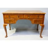 A Queen Anne style burr walnut low boy, with a cross-banded top, two frieze drawers over two shorter