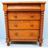 A 19th Century faded walnut chest of four long drawers with turned pulls, bobbin pilasters and