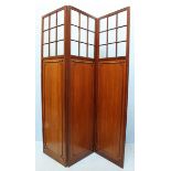 An early 20th century stained walnut three-fold screen, the top section with nine-panel astragal