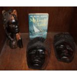 SECTION 39. A group of three dark wood carvings of African women, together with a signed first