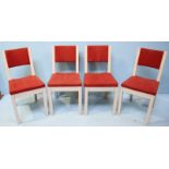 Four white painted pine standard chairs with red fabric upholstery.