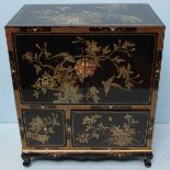 A 20th Century Oriental lacquer cabinet, the two central doors opening to reveal storage space, over