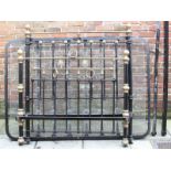 A Victorian black painted metal bed frame with brass detailing, together with a later, iron, folding