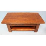 A 20th Century oak coffee table, the planked top with cleated ends, over a single frieze drawer