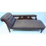 A Victorian mahogany chaise lounge, with blue, floral fabric upholstery, scrolled and carved frame