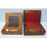 Two walnut writing slopes, both with fitted interiors, one with two glass inkwells, (2)