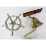 A small stainless steel ships wheel, together with a 20th century brass bell, mounted to wooden