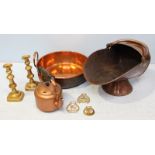 A small collection of metalware items including a pair of brass candlesticks, a copper preserve pan,