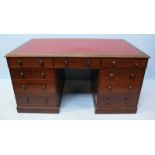 A late 19th century mahogany partners desk, the top with red leather scribe, above three frieze