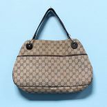 A ladies Gucci handbag, with open top, brown leather straps and chrome fittings