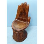 An ethnic South African hardwood seat in the form of an open hand, 68cm high