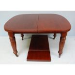 An Edwardian walnut extending dining table, raised on shaped and turned supports. Table measures