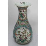 A late 19th/early 20th Century Canton enamel vase, painted with birds amidst flowers in polychrome