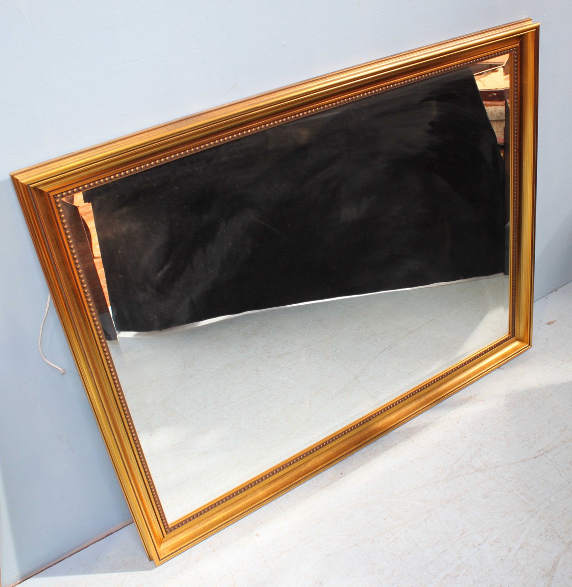 A 20th century gilt framed bevelled mirror. 113 x 87cm.