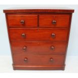 A large Victorian mahogany chest of two short over three long graduated drawers, raised on a