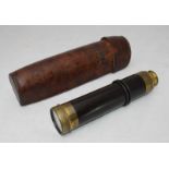 A late 19th/early 20th century brass five draw telescope, with wooden grip, with closing viewer