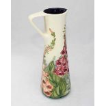 A Moorcroft 'Amberwood Foxglove' pouring jug, designed and signed by Rachel Bishop, dated 2002 and