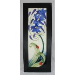 A Moorcroft ceramic plaque "Fly away home" designed by Rachel Bishop, mounted in wooden frame,