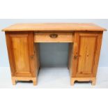 A 19th Century pine desk with single frieze drawer, flanked by two cupboard doors enclosing