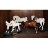 SECTION 33. Three Royal Doulton white horse figure-groups together with a Beswick ceramic horse, (