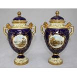 A pair of Edwardian Coalport porcelain vases and covers, of ovoid form, with handles to either