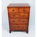 An Edwardian stained mahogany narrow chest of two short over three long graduated drawers with brass