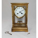 An Edwardian French gilt mantel clock, the white enamel dial with Arabic numerals denoting hours,