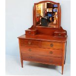 An Edwardian inlaid mahogany dressing table, the central shaped mirror above two short drawers