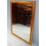 A large 20th century gilt framed, bevelled wall mirror. 138 x 107cm.