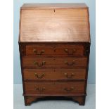 An Edwardian faded mahogany fall-front bureau, with four drawers beneath, 63cm wide