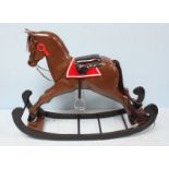 A 20th century painted wooden rocking horse mounted on curved rocker, studded black leather seat,