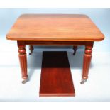 A Victorian faded walnut dining table, raised on reeded, turned supports to sabot castors. 150cm