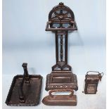 Four various iron items including a walking stick stand, a boot scrape, a clothes iron and a