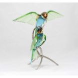 A Swarovski crystal 'Bee Eaters peridot' figurine, depicting two birds sitting upon chrome metal