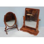 A 19th century faded mahogany platform mirror, together with an oval swinging mirror with bevelled