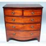 A Georgian mahogany bow fronted chest of two short over three long graduated drawers with brass