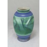 A modern Poole Pottery Studio vase decorated with swimming fish and seashells, designed by Sally