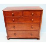 A large 19th century mahogany chest of two short over three long, graduated drawers, with turned