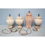 A group of three modern matching ceramic lamps with ribbed decoration and gilt detailing,