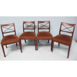 A set of four 19th century standard chairs with X-backs, brown fabric stuff-over seats and raised on